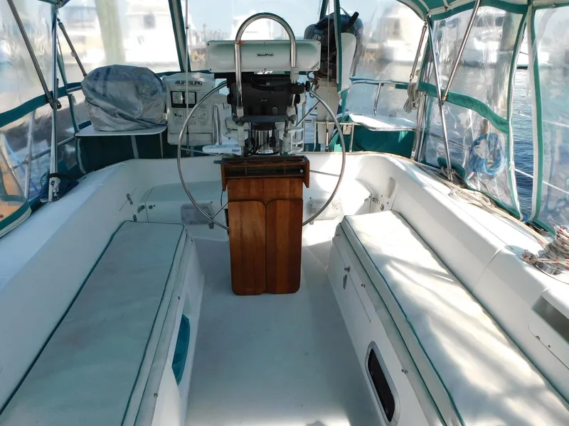 Slide: The Image of Interior view of a 1998 Catalina 34 Mark II sailboat cockpit with seating and steering wheel. - 8