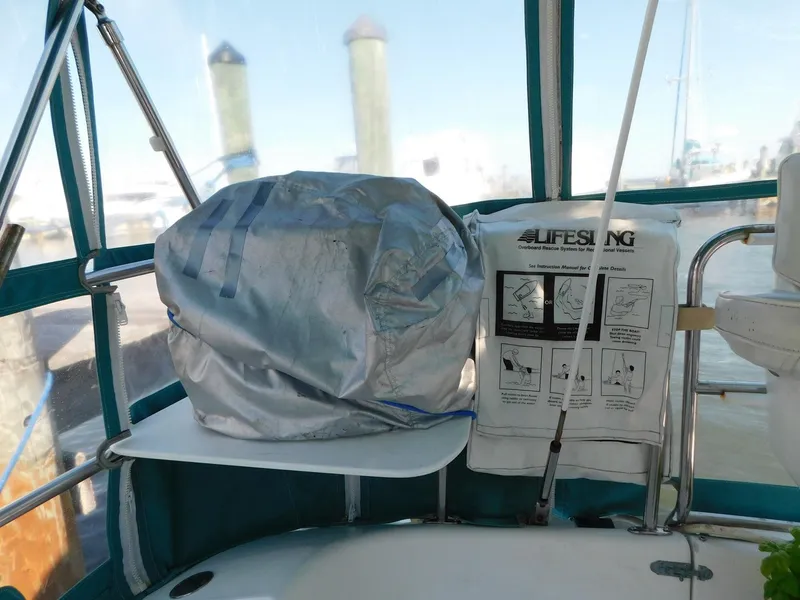 Slide: The Image of Covered equipment and Lifesling on a 1998 Catalina 34 Mark II sailboat deck. - 9