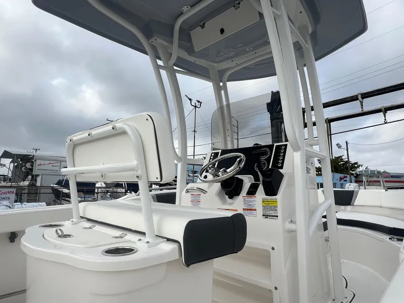 Slide: The Image of 2025 Robalo R222 boat interior with steering console and seating. - 11