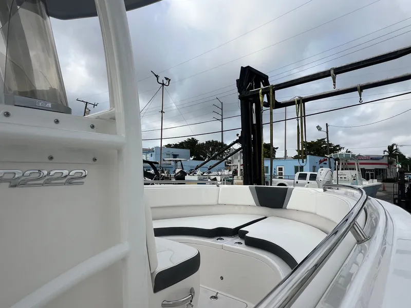 Slide: The Image of 2025 Robalo R222 boat with sleek design, docked under cloudy skies. - 12
