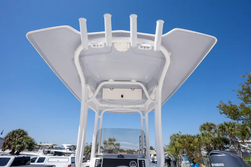 Slide: The Image of 2025 Robalo R222 boat T-top against clear blue sky. - 16