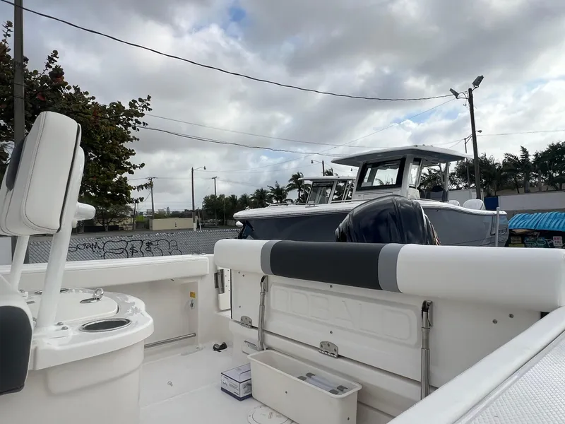 Slide: The Image of 2025 Robalo R222 boat interior with seating and equipment, under cloudy sky. - 19