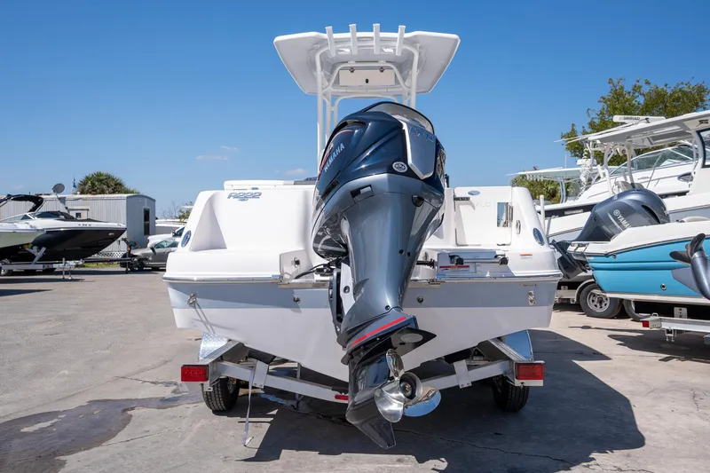 Slide: The Image of 2025 Robalo R222 boat with Yamaha outboard motor on trailer, parked outdoors. - 23