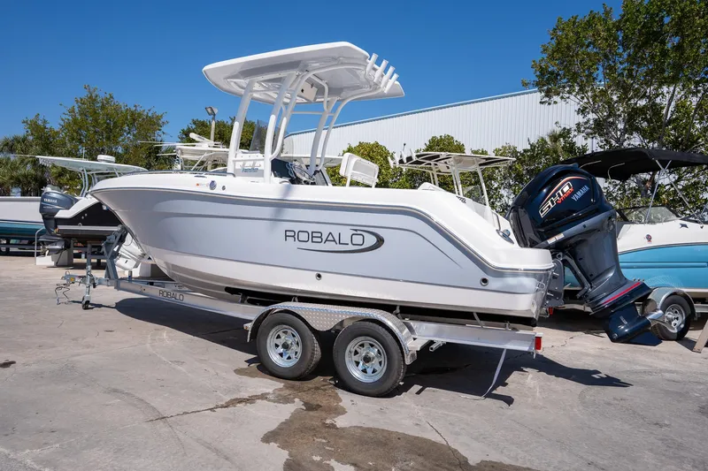 Slide: The Image of 2025 Robalo R222 boat on trailer, featuring Yamaha outboard motor, parked outdoors. - 3
