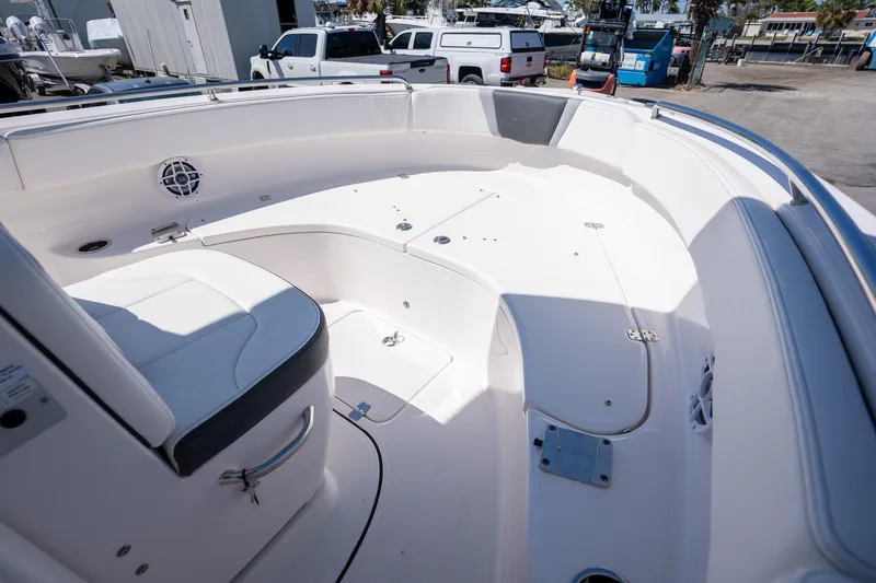 Slide: The Image of 2025 Robalo R222 boat interior with white seating and storage compartments. - 8