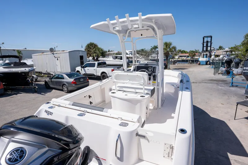 Slide: The Image of 2025 Robalo R222 boat in a marina, featuring a sleek design and modern console. - 9