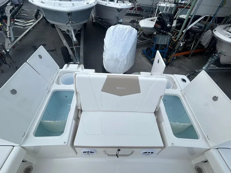 Slide: The Image of 2025 Robalo 246 Cayman boat interior with seating and storage compartments. - 12