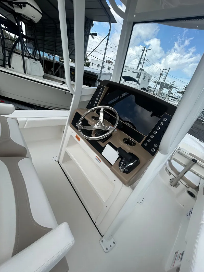 Slide: The Image of 2025 Robalo 246 Cayman boat cockpit with modern steering and control panel. - 6