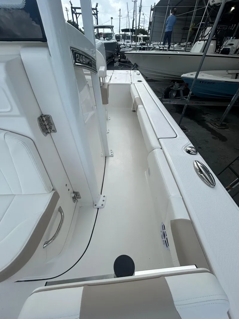 Slide: The Image of 2025 Robalo 246 Cayman boat interior, showcasing sleek white seating and modern design. - 7
