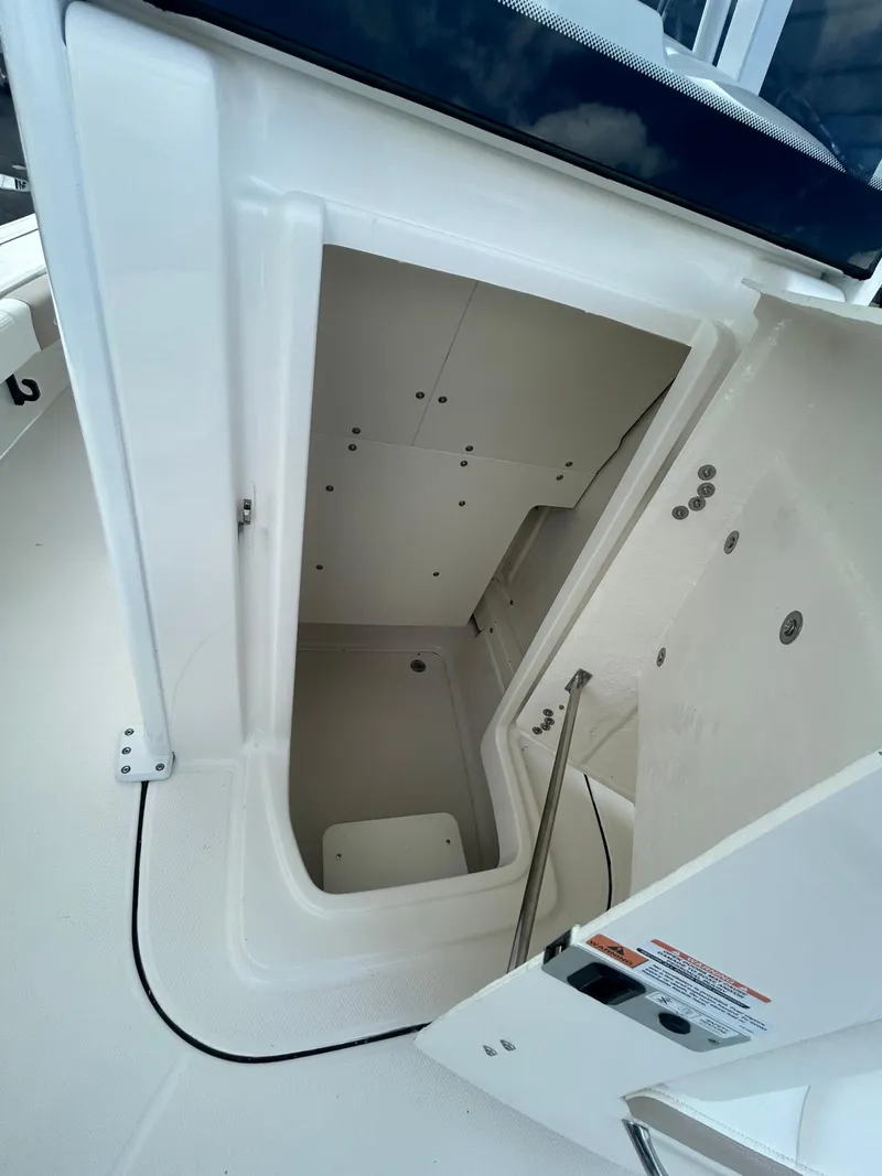 Slide: The Image of Open storage compartment on 2025 Robalo 246 Cayman boat, showcasing interior space and design. - 9