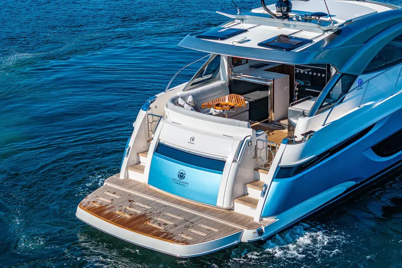 Slide: The Image of 2025 Riviera 4600 Sport Yacht cruising on blue ocean waters. - 11