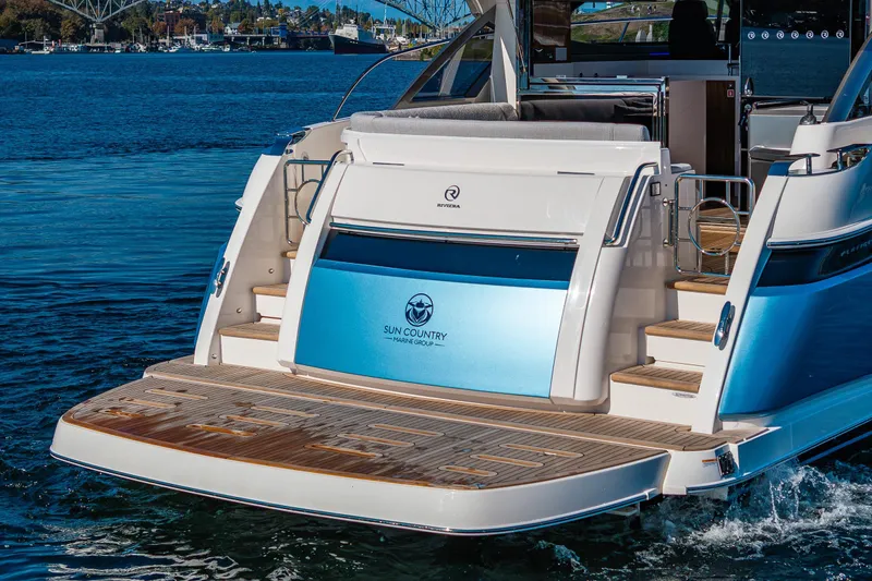 Slide: The Image of 2025 Riviera 4600 Sport Yacht on water, showcasing elegant rear deck design. - 12