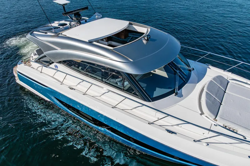 Slide: The Image of 2025 Riviera 4600 Sport Yacht cruising on open water, showcasing sleek design and luxury features. - 13