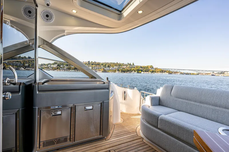 Slide: The Image of Luxurious 2025 Riviera 4600 Sport Yacht interior with scenic waterfront view. - 21