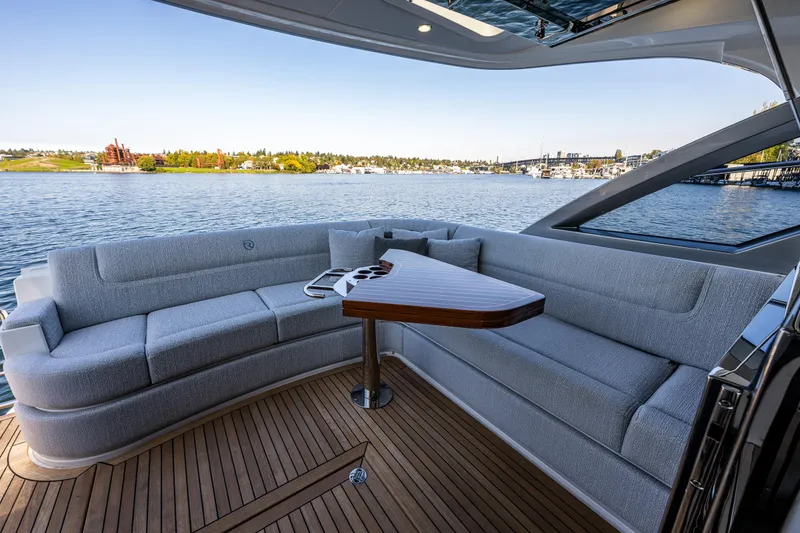 Slide: The Image of Luxurious seating area on 2025 Riviera 4600 Sport Yacht with scenic waterfront view. - 22