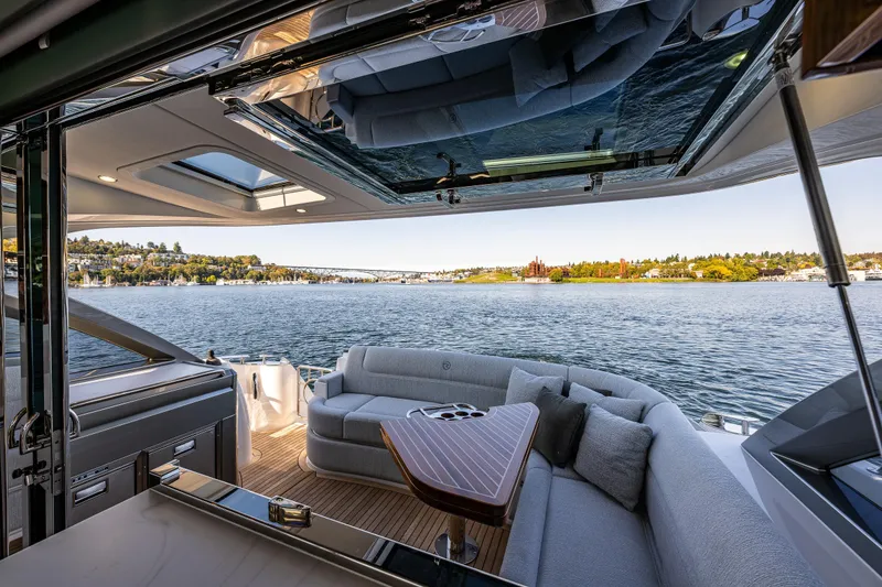 Slide: The Image of Luxurious 2025 Riviera 4600 Sport Yacht interior with scenic waterfront view. - 23