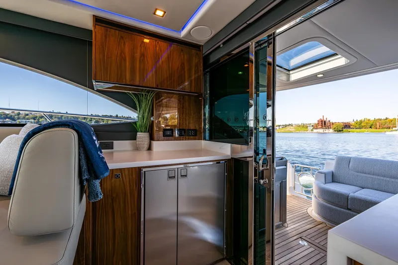 Slide: The Image of Luxurious interior of 2025 Riviera 4600 Sport Yacht with waterfront view. - 25