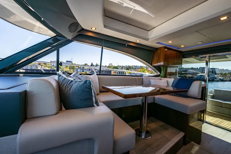 Slide: The Image of Luxurious interior of 2025 Riviera 4600 Sport Yacht with elegant seating and panoramic windows. - 27