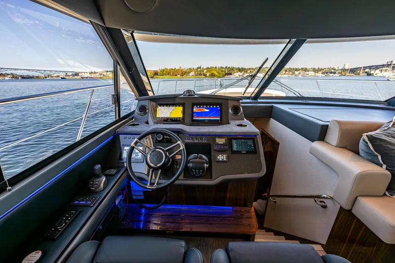 Slide: The Image of Helm of 2025 Riviera 4600 Sport Yacht with modern navigation systems and panoramic view. - 30
