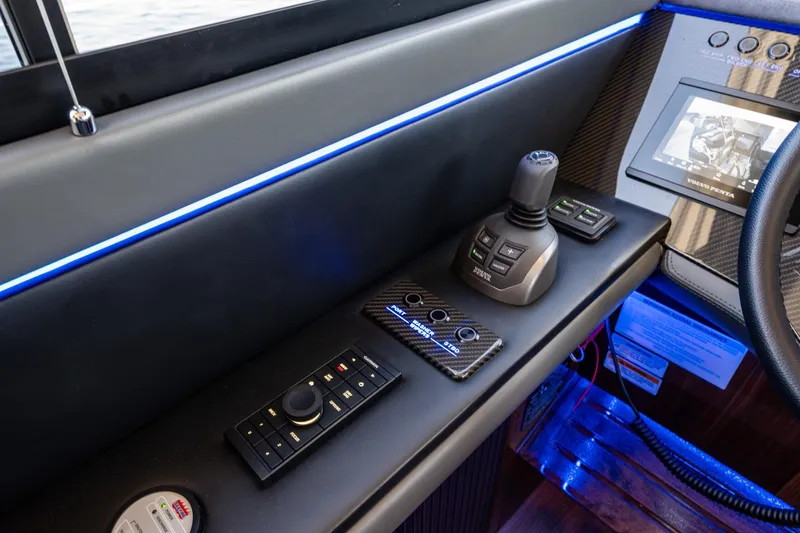 Slide: The Image of Control panel of 2025 Riviera 4600 Sport Yacht with joystick and digital display. - 32