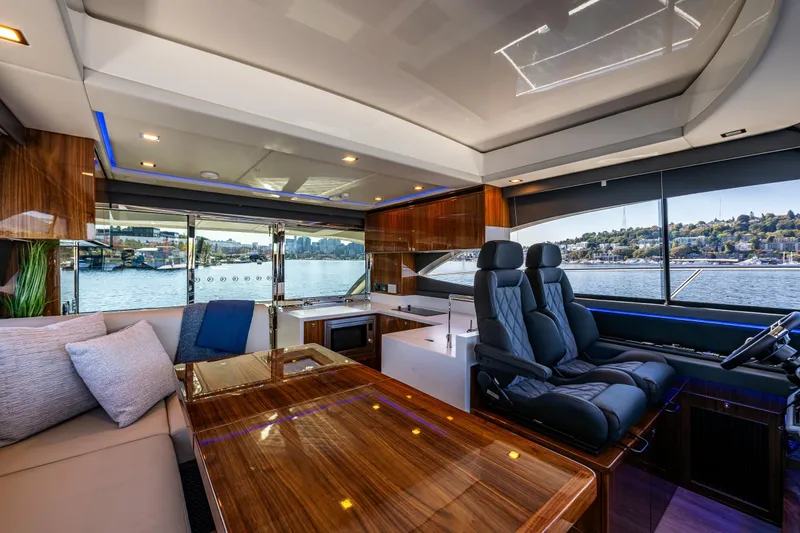 Slide: The Image of Luxurious interior of 2025 Riviera 4600 Sport Yacht with plush seating and panoramic windows. - 35