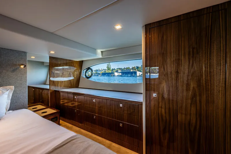 Slide: The Image of Luxurious interior of 2025 Riviera 4600 Sport Yacht with wood finish and scenic window view. - 39