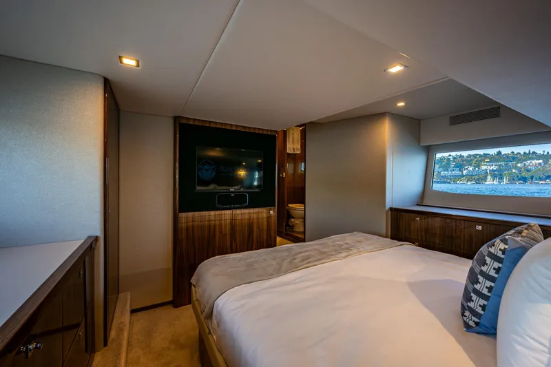 Slide: The Image of Luxurious bedroom interior of 2025 Riviera 4600 Sport Yacht with scenic window view. - 40