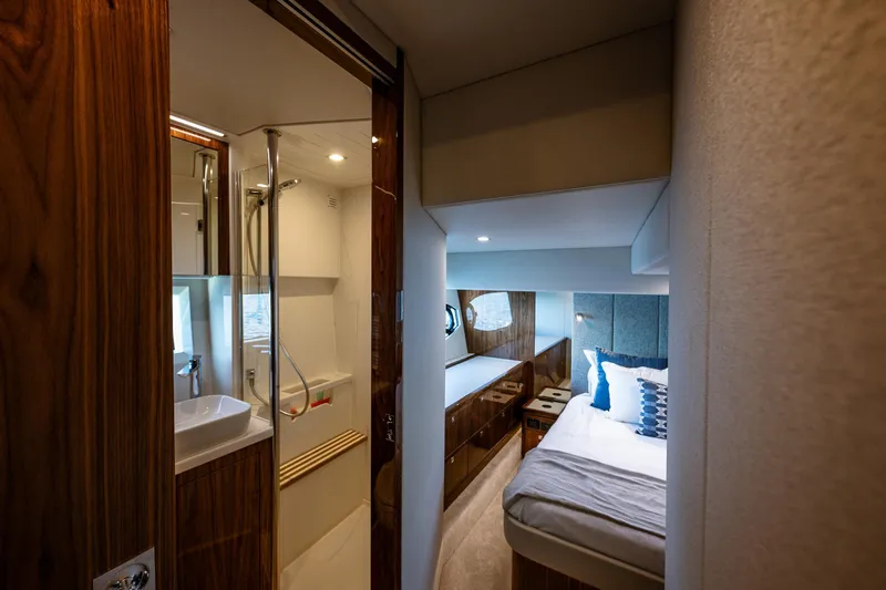 Slide: The Image of Luxurious interior of 2025 Riviera 4600 Sport Yacht featuring bedroom and bathroom. - 41