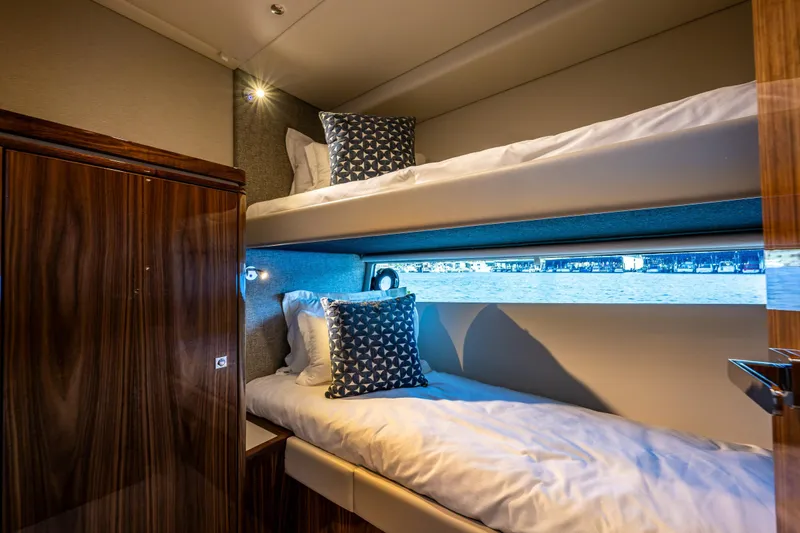 Slide: The Image of Luxurious cabin with bunk beds in 2025 Riviera 4600 Sport Yacht. - 46