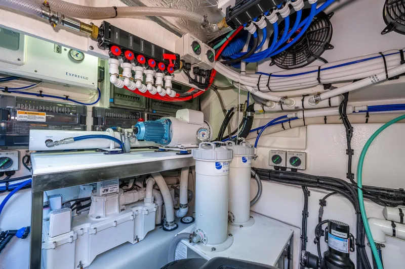 Slide: The Image of Engine room of 2025 Riviera 4600 Sport Yacht with complex piping and machinery. - 49