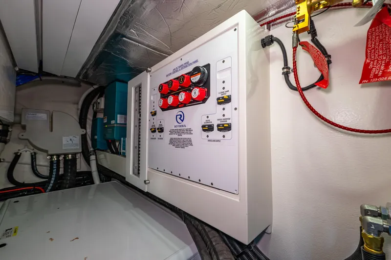 Slide: The Image of Electrical panel in 2025 Riviera 4600 Sport Yacht engine room, showcasing wiring and controls. - 55