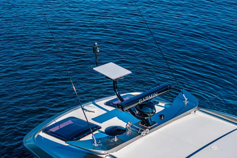 Slide: The Image of Riviera 4600 Sport Yacht 2025 with Garmin equipment on calm blue water. - 7