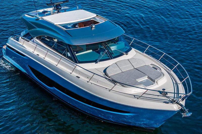 Slide: The Image of 2025 Riviera 4600 Sport Yacht cruising on blue water, showcasing sleek design and luxury features. - 8