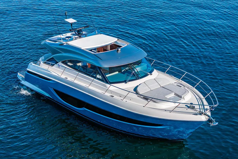 Slide: The Image of 2025 Riviera 4600 Sport Yacht cruising on open water, showcasing sleek design and luxury features. - 9