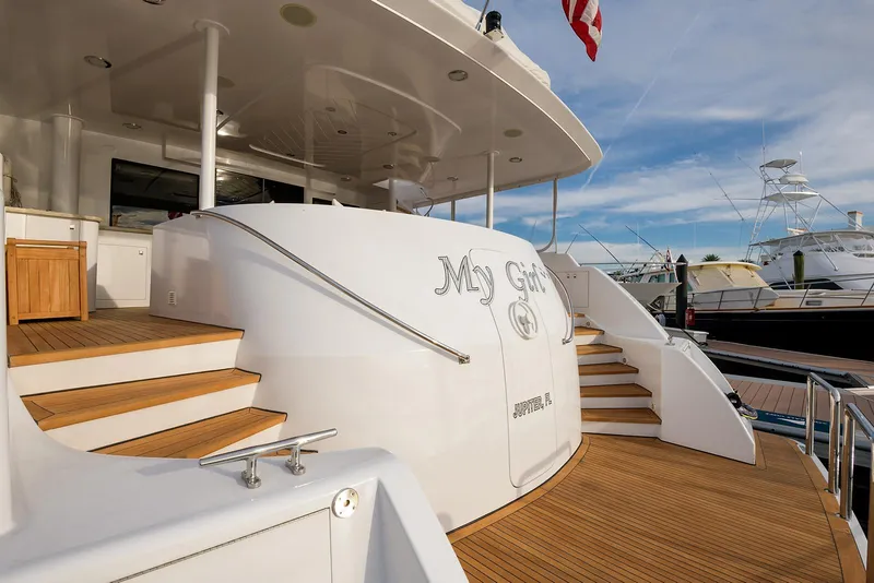 Slide: The Image of Luxury yacht "My Girl" docked, featuring elegant wooden steps and sleek design, Westport 95 Raised Pilothouse MY. - 4