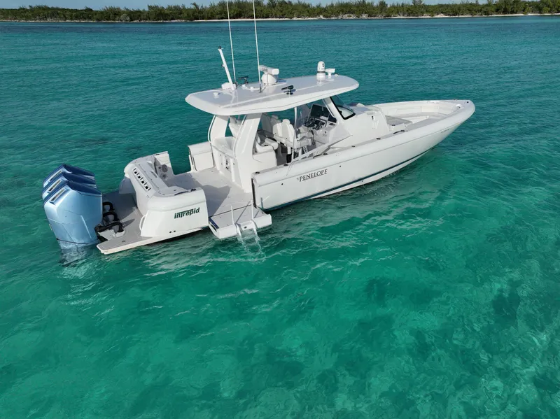 Slide: The Image of 2023 Intrepid 427 Nomad SE boat on clear turquoise water. - 1