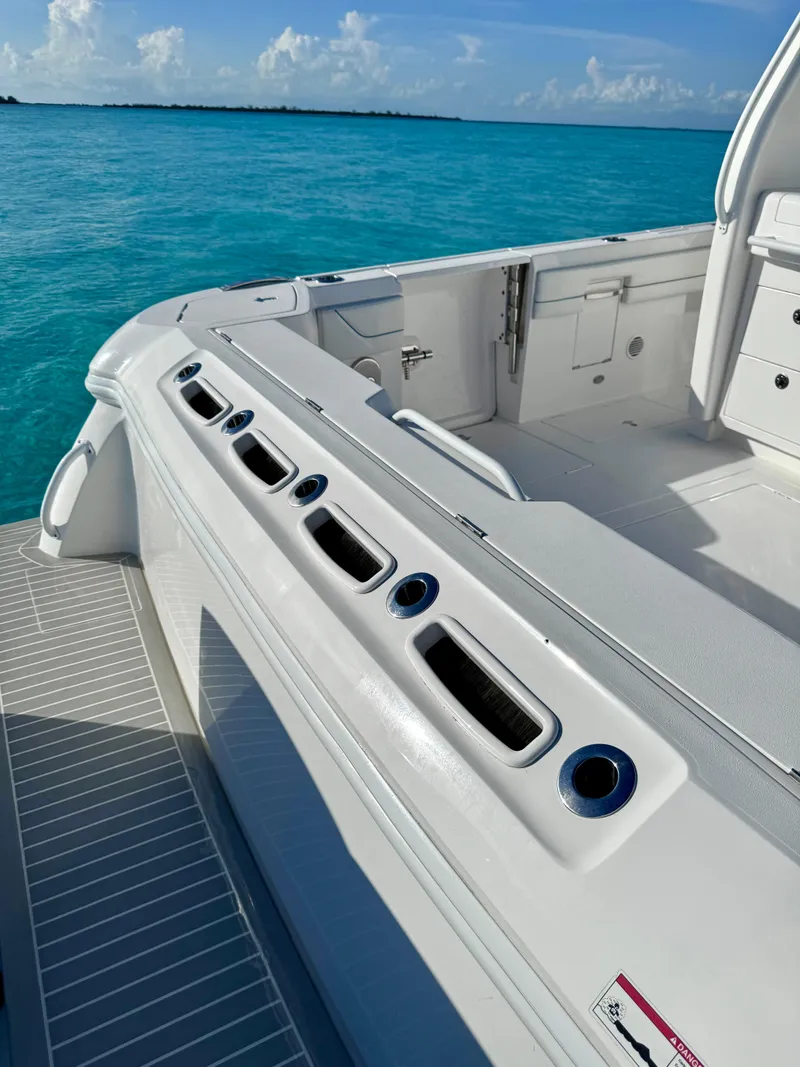 Slide: The Image of 2023 Intrepid 427 Nomad SE boat, sleek white deck, turquoise ocean backdrop. - 10