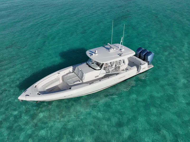 Slide: The Image of 2023 Intrepid 427 Nomad SE boat on clear turquoise water. - 16