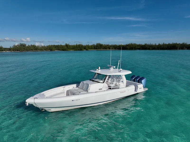 Slide: The Image of 2023 Intrepid 427 Nomad SE boat on clear turquoise water, under a blue sky. - 18