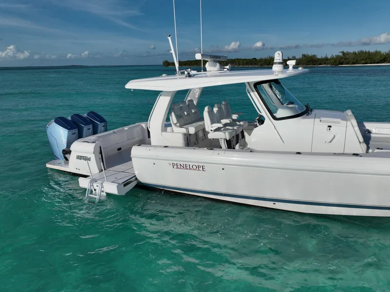 Slide: The Image of 2023 Intrepid 427 Nomad SE boat on turquoise water, side view. - 2