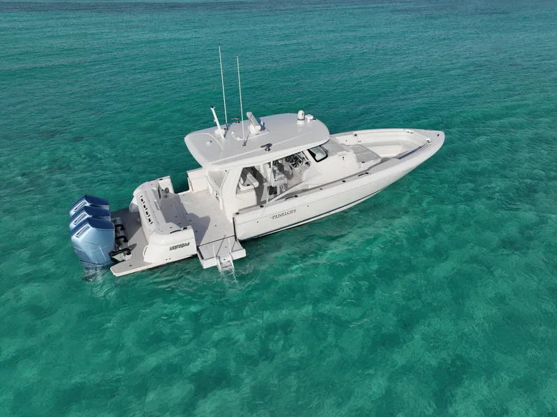 Slide: The Image of 2023 Intrepid 427 Nomad SE boat on clear turquoise water. - 20