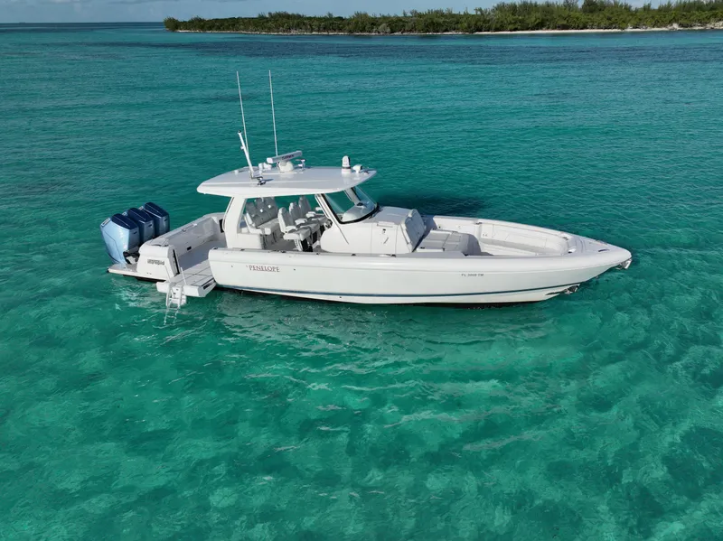 Slide: The Image of 2023 Intrepid 427 Nomad SE boat on clear turquoise water. - 21