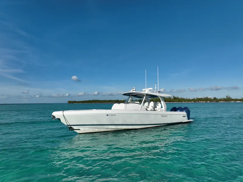 Slide: The Image of 2023 Intrepid 427 Nomad SE boat on clear blue water under a sunny sky. - 22