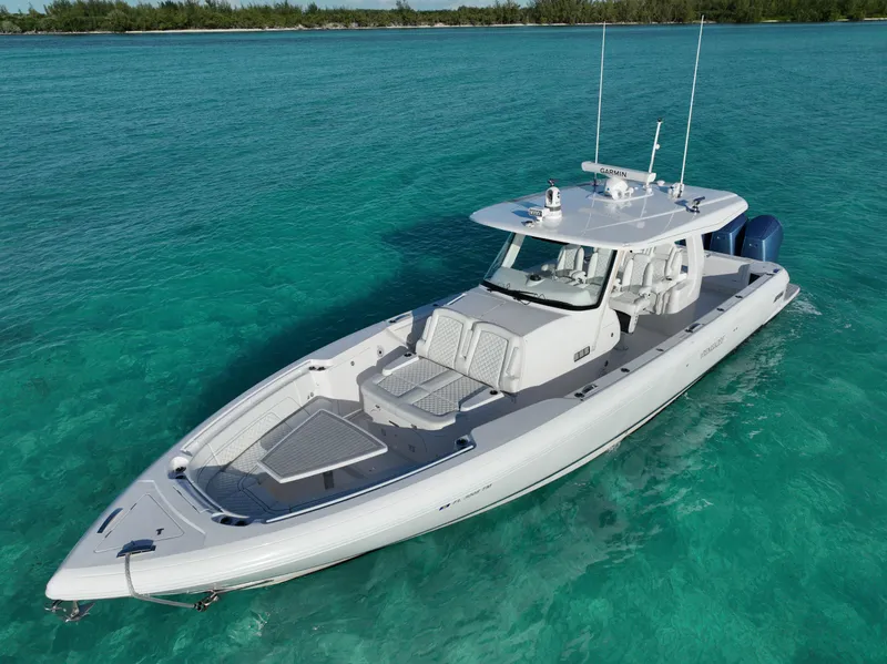 Slide: The Image of 2023 Intrepid 427 Nomad SE boat on clear turquoise water. - 24