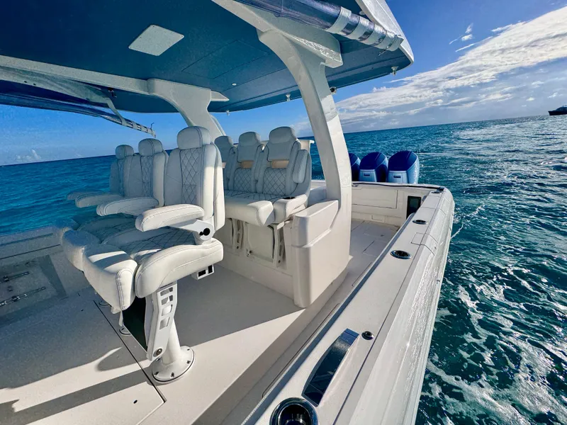 Slide: The Image of 2023 Intrepid 427 Nomad SE boat with luxurious seating on open water. - 4