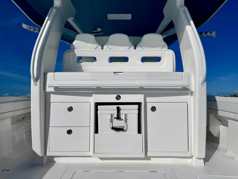 Slide: The Image of 2023 Intrepid 427 Nomad SE boat interior with seating and storage compartments. - 9