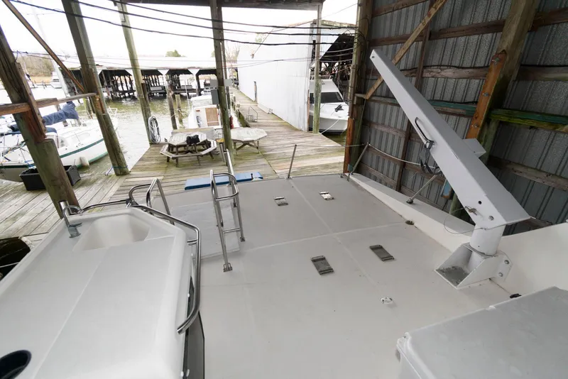 Slide: The Image of 1998 Bayliner 4788 Pilot House Motoryacht docked in a covered marina. - 10