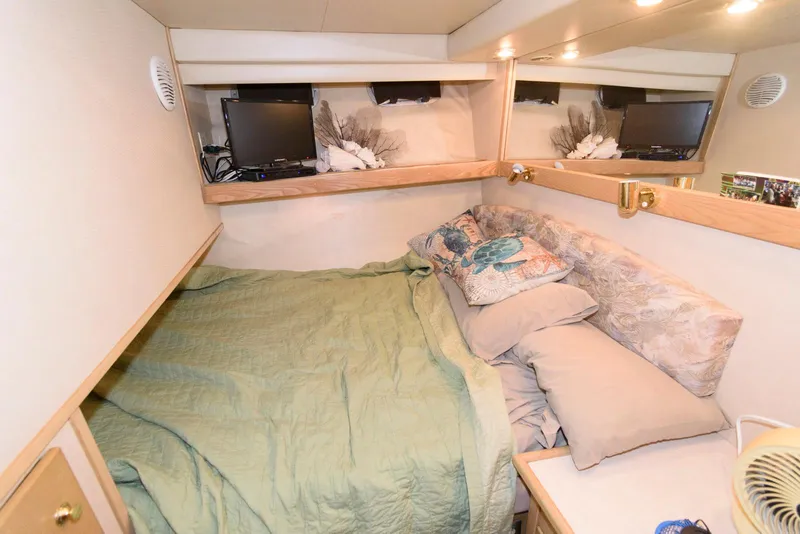 Slide: The Image of Cozy bedroom in 1998 Bayliner 4788 Pilot House Motoryacht with TV and green bedding. - 18