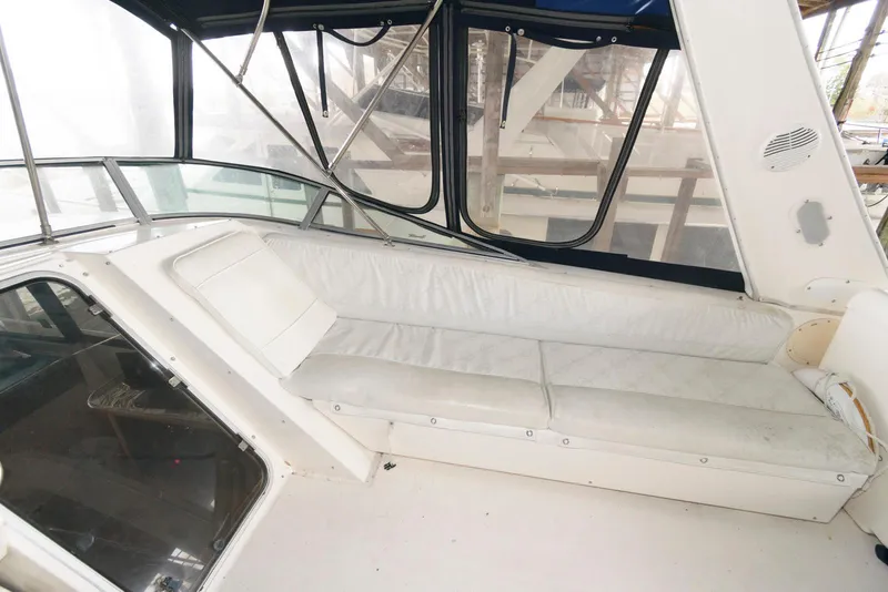 Slide: The Image of 1998 Bayliner 4788 Pilot House Motoryacht interior with white seating and windows. - 8