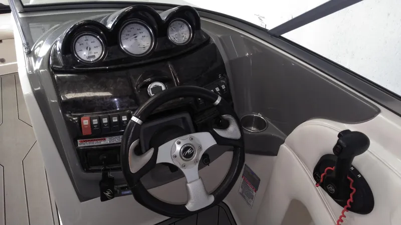 Slide: The Image of 2008 Monterey 254 FS boat dashboard with steering wheel and gauges. - 10